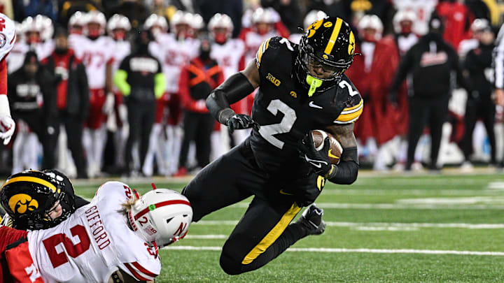 Nov 29, 2024; Iowa City, Iowa, USA; Iowa Hawkeyes running back Kaleb Johnson (2) runs the ball as Nebraska Cornhuskers defensive back Isaac Gifford (2) makes the tackle during the third quarter at Kinnick Stadium. Mandatory Credit: Jeffrey Becker-Imagn Images Nov 29, 2024; Iowa City, Iowa, USA; Iowa Hawkeyes running back Kaleb Johnson (2) runs the ball as Nebraska Cornhuskers defensive back Isaac Gifford (2) makes the tackle during the third quarter at Kinnick Stadium. Mandatory Credit: Jeffrey Becker-Imagn Images