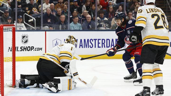 Mar 29, 2026; Columbus, Ohio, USA; Boston Bruins goalie Jeremy Swayman (1) makes a save as Columbus Blue Jackets right wing Kirill Marchenko (86) looks for a rebound during the second period at Nationwide Arena. Mandatory Credit: Russell LaBounty-Imagn Images