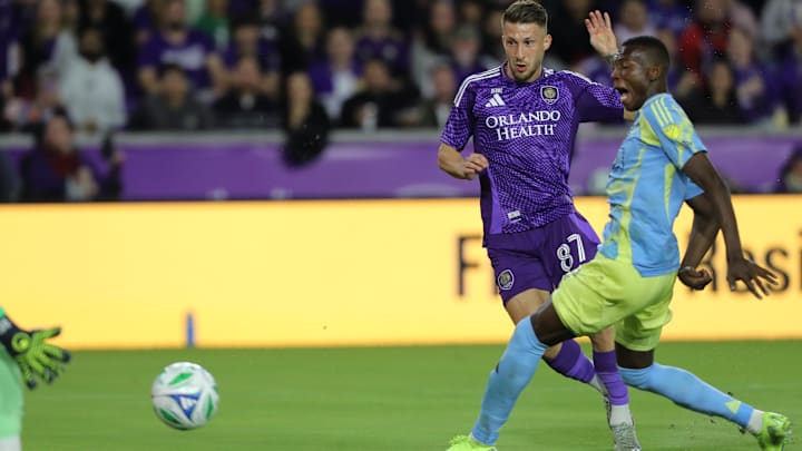 Feb 22, 2025; Orlando, Florida, USA; Orlando City forward Marco Pasalic (87) shoots and scores a goal against Philadelphia Union midfielder Danley Jean Jacques (21) in the first half at Inter&Co Stadium. Mandatory Credit: Morgan Tencza-Imagn Images