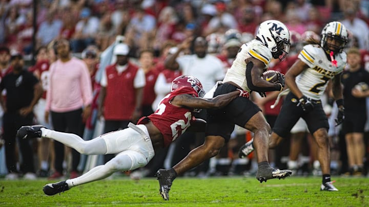 Oct 26, 2024; Tuscaloosa, Alabama, USA; Alabama Crimson Tide defensive back Jahlil Hurley (25) grabs onto Missouri Tigers running back Marcus Carroll (9) during the fourth quarter at Bryant-Denny Stadium. Mandatory Credit: Will McLelland-Imagn Images Oct 26, 2024; Tuscaloosa, Alabama, USA; Alabama Crimson Tide defensive back Jahlil Hurley (25) grabs onto Missouri Tigers running back Marcus Carroll (9) during the fourth quarter at Bryant-Denny Stadium. Mandatory Credit: Will McLelland-Imagn Images