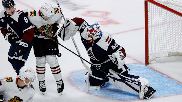 Oct 28, 2024; Denver, Colorado, USA; Colorado Avalanche goaltender Alexandar Georgiev (40) makes a save as Chicago Blackhawks center Ryan Donato (8) and defenseman Cale Makar (8) battle for position in the first period at Ball Arena. Mandatory Credit: Isaiah J. Downing-Imagn Images