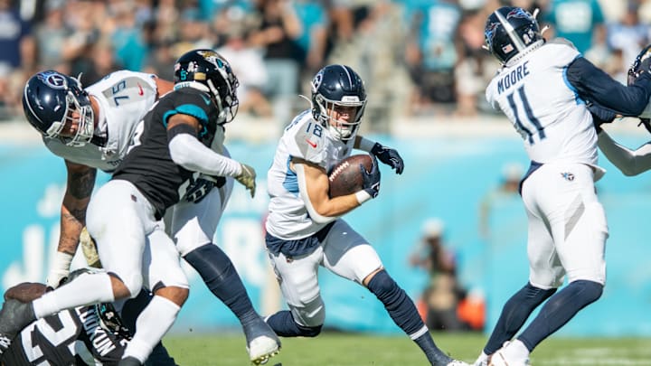 Nov 19, 2023; Jacksonville, Florida, USA; Tennessee Titans wide receiver Kyle Philips (18) runs the ball after the catch against the Jacksonville Jaguars in the second quarter at EverBank Stadium. Mandatory Credit: Jeremy Reper-USA TODAY Sports
