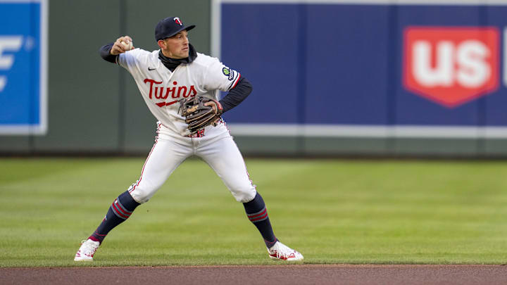 Apr 6, 2026; Minneapolis, Minnesota, USA; Minnesota Twins shortstop Brooks Lee (22) throws the ball to first base for an out against the Detroit Tigers in the first inning at Target Field.
