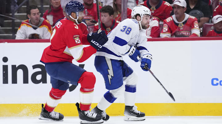 Apr 28, 2025; Sunrise, Florida, USA; Tampa Bay Lightning left wing Brandon Hagel (38) passes the puck against Florida Panthers defenseman Seth Jones (3) during the first period in game four of the first round of the 2025 Stanley Cup Playoffs at Amerant Bank Arena. Mandatory Credit: Rich Storry-Imagn Images Apr 28, 2025; Sunrise, Florida, USA; Tampa Bay Lightning left wing Brandon Hagel (38) passes the puck against Florida Panthers defenseman Seth Jones (3) during the first period in game four of the first round of the 2025 Stanley Cup Playoffs at Amerant Bank Arena. Mandatory Credit: Rich Storry-Imagn Images