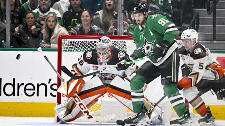 Jan 25, 2024; Dallas, Texas, USA; Anaheim Ducks goaltender John Gibson (36) and Dallas Stars center Tyler Seguin (91) look for the puck in the Ducks zone during the third period at the American Airlines Center. Mandatory Credit: Jerome Miron-Imagn Images