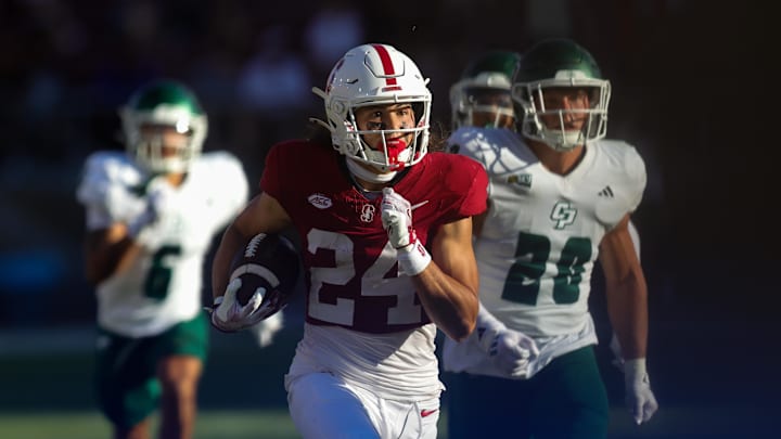 Sep 7, 2024; Stanford, California, USA; Stanford Cardinal wide receiver Tiger Bachmeier (24) returns a punt for a touchdown against the Cal Poly Mustangs during the second half at Stanford Stadium. Mandatory Credit: Sergio Estrada-Imagn Images