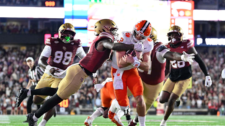 Oct 11, 2025; Chestnut Hill, Massachusetts, USA; Clemson Tigers quarterback Cade Klubnik (2) runs through a tackle by Boston College Eagles defensive back Max Tucker (3) for a touchdown during the first half at Alumni Stadium. Mandatory Credit: Eric Canha-Imagn Images
