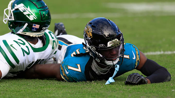 Jacksonville Jaguars wide receiver Brian Thomas Jr. (7) comes up with a face full of turf against New York Jets safety Tony Adams (22) during the third quarter Sunday, Dec. 15, 2024 at EverBank Stadium in Jacksonville, Fla. The Jets held off the Jaguars 32-25.