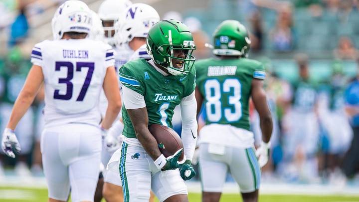 Aug 30, 2025; New Orleans, Louisiana, USA; Tulane Green Wave wide receiver Omari Hayes (1) reacts to catching a pass against Northwestern Wildcats defensive back Braden Turner (9) during the first half at Yulman Stadium. Mandatory Credit: Stephen Lew-Imagn Images
