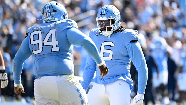 Oct 25, 2025; Chapel Hill, North Carolina, USA;  North Carolina Tar Heels defensive lineman Isaiah Johnson (94) celebrtates with defensive tackle D'Antre Robinson (6) after making a sack in the second quarer at Kenan Stadium. Mandatory Credit: Bob Donnan-Imagn Images