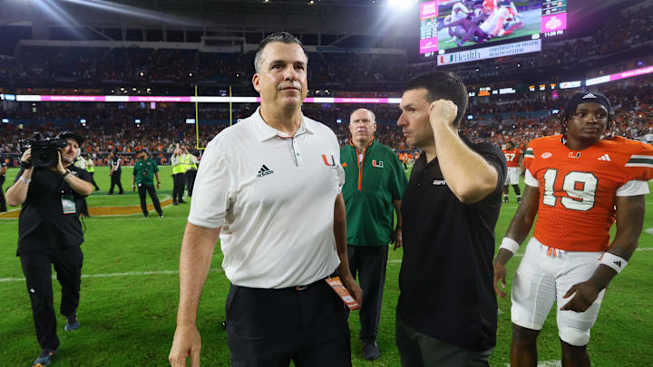 Sep 27, 2024; Miami Gardens, Florida, USA; Miami Hurricanes head coach Mario Cristobal walks on the field against the Virginia Tech Hokies as game officials review the last play of the game at Hard Rock Stadium. Mandatory Credit: Sam Navarro-Imagn Images Sep 27, 2024; Miami Gardens, Florida, USA; Miami Hurricanes head coach Mario Cristobal walks on the field against the Virginia Tech Hokies as game officials review the last play of the game at Hard Rock Stadium. Mandatory Credit: Sam Navarro-Imagn Images