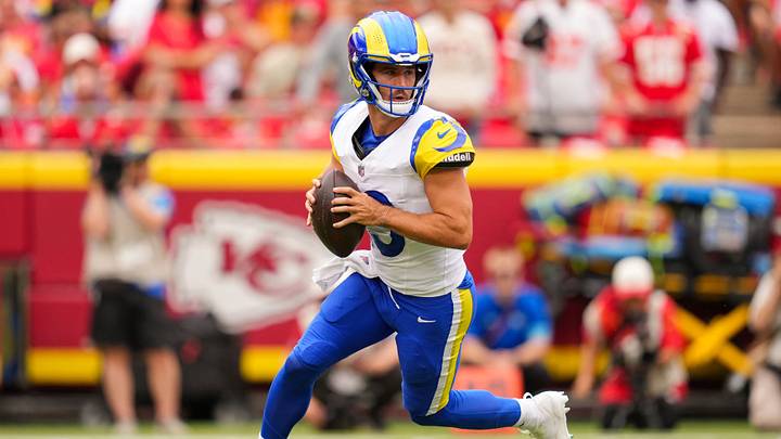 Aug 15, 2026; Kansas City, Missouri, USA; Los Angeles Rams quarterback Stetson Bennett IV (13) rolls out to pass during the first half against the Kansas City Chiefs at at Arrowhead Stadium. Mandatory Credit: Jay Biggerstaff-Imagn Images