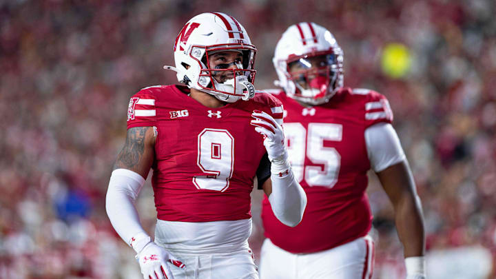 Oct 11, 2025; Madison, Wisconsin, USA; Wisconsin Badgers safety Austin Brown (9) and defensive lineman Brandon Lane Jr. (95) look at the scoreboard in the second half against the Iowa Hawkeyes at Camp Randall Stadium. Mandatory Credit: Ross Harried-Imagn Images