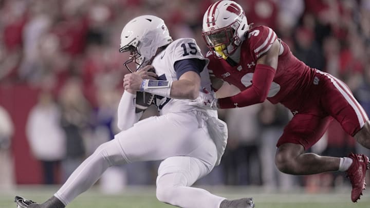 Penn State quarterback Drew Allar is stopped short off a first down by Wisconsin Badgers cornerback Nyzier Fourqurean during the first quarter at Camp Randall Stadium.