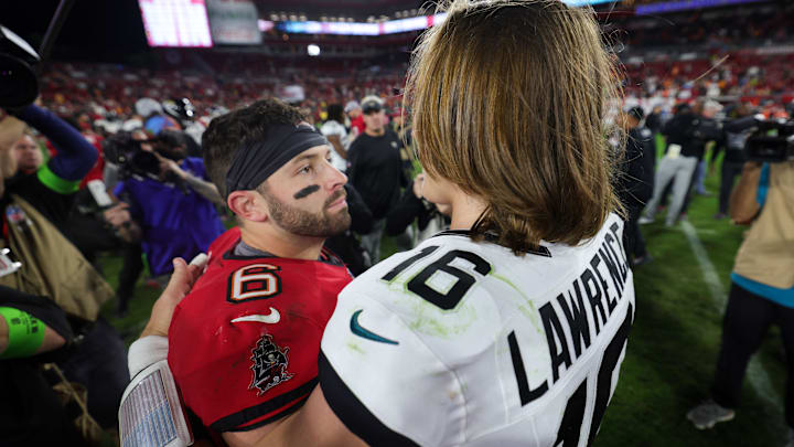Dec 24, 2023; Tampa, Florida, USA;  Tampa Bay Buccaneers quarterback Baker Mayfield (6) greats Jacksonville Jaguars quarterback Trevor Lawrence (16) after a game at Raymond James Stadium. Mandatory Credit: Nathan Ray Seebeck-Imagn Images