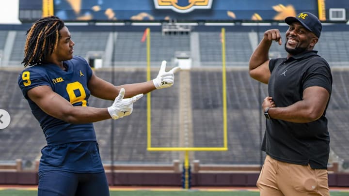 Four-star 2025 defensive lineman Nathaniel Marshall poses with Michigan head football coach Sherrone Moore in the Big House during a recruiting visit to Ann Arbor.