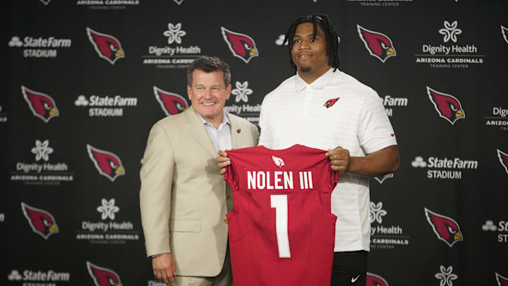 Cardinals defensive lineman Walter Nolen stands and holds his jersey with owner Michael Bidwill (left) during his introductory news conference inside the Arizona Cardinals training facility on April 25, 2025, in Tempe.