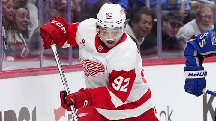 Mar 25, 2025; Denver, Colorado, USA; Detroit Red Wings center Marco Kasper (92) controls the puck in the first period against the Colorado Avalanche at Ball Arena. Mandatory Credit: Ron Chenoy-Imagn Images