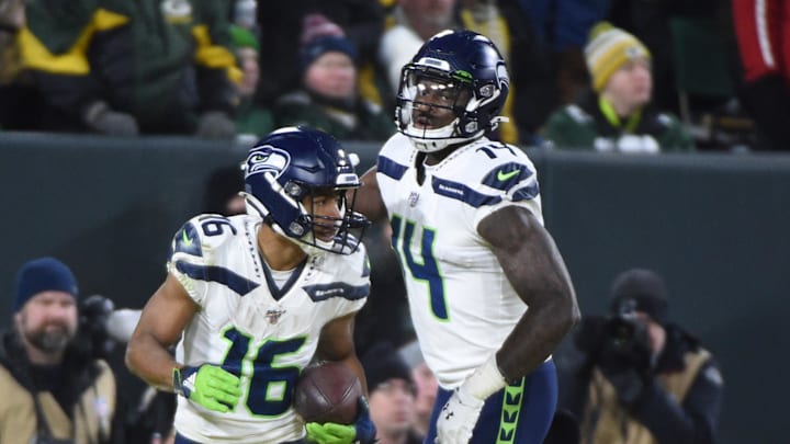 Jan 12, 2020; Green Bay, WI, USA; Seattle Seahawks wide receiver Tyler Lockett (16) celebrates with wide receiver D.K. Metcalf (14) after scoring a touchdown against the Green Bay Packers  in the third quarter of a NFC Divisional Round playoff football game at Lambeau Field.