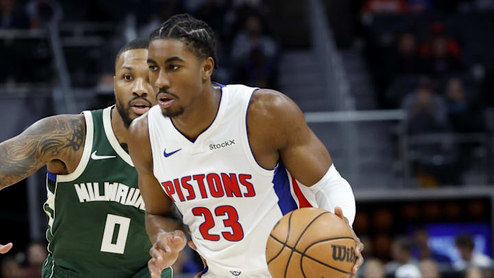 Oct 6, 2024; Detroit, Michigan, USA;  Detroit Pistons guard Jaden Ivey (23) dribbles on Milwaukee Bucks guard Damian Lillard (0) in the first half at Little Caesars Arena. Mandatory Credit: Rick Osentoski-Imagn Images