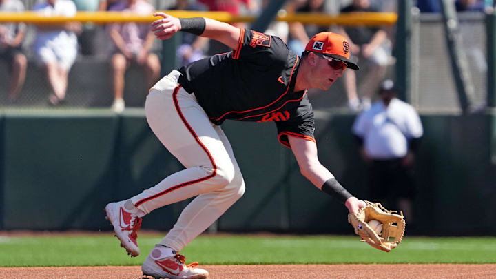 Mar 2, 2025; Scottsdale, Arizona, USA; San Francisco Giants second baseman Tyler Fitzgerald (49) fields a ground ball during the first inning at Scottsdale Stadium.