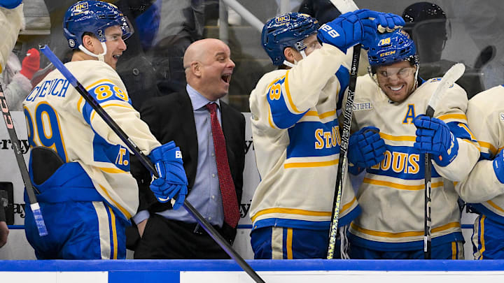 Feb 8, 2025; St. Louis, Missouri, USA;  St. Louis Blues left wing Pavel Buchnevich (89) head coach Jim Montgomery center Dylan Holloway (81) and center Robert Thomas (18) react after center Radek Faksa (not pictured) scored the game winning goal in the 10th round of shootouts against the Chicago Blackhawks at Enterprise Center. Mandatory Credit: Jeff Curry-Imagn Images