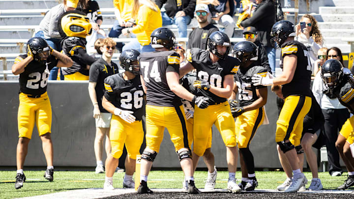 Apr 26, 2025; Iowa City, IA, USA; Iowa Hawkeyes players Kamari Moulton (28) back Xavier Williams (26) Bodey McCaslin (74) Michael Burt (80) and Nathan McNeil (25) celebrate during a spring NCAA football open practice at Kinnick Stadium. Mandatory Credit: Joseph Cress/For the Register