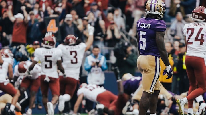 The Cougars react to their big stop at the end of the 2024 Apple Cup while Giles Jackson looks on forlornly. The Cougars react to their big stop at the end of the 2024 Apple Cup while Giles Jackson looks on forlornly.