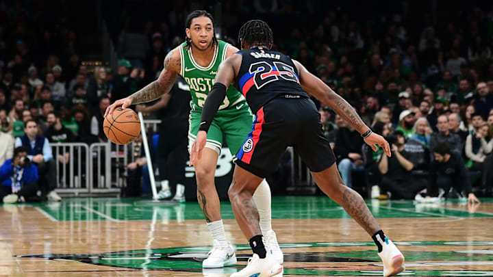 Dec 12, 2024; Boston, Massachusetts, USA; Boston Celtics guard JD Davison (20) dribbles against Detroit Pistons guard Marcus Sasser (25) during the second half at TD Garden.