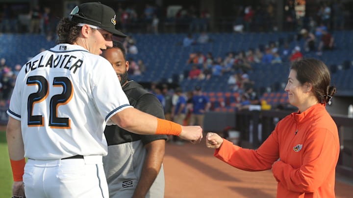 Akron RubberDucks assistant athletic trainer Karina Gonzalez gets a first bump from Chase DeLauter before the game against Erie on Tuesday, April 16, 2024, in Akron, Ohio. [Phil Masturzo/ Beacon Journal]