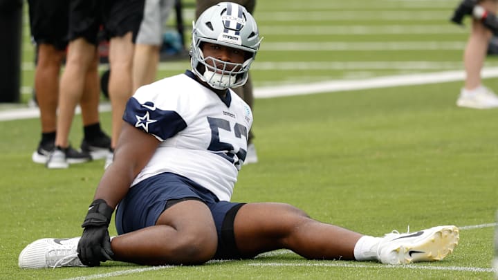 Dallas Cowboys guard Tyler Booker goes through a drill during practice at the Ford Center at the Star Training Facility. Dallas Cowboys guard Tyler Booker goes through a drill during practice at the Ford Center at the Star Training Facility.