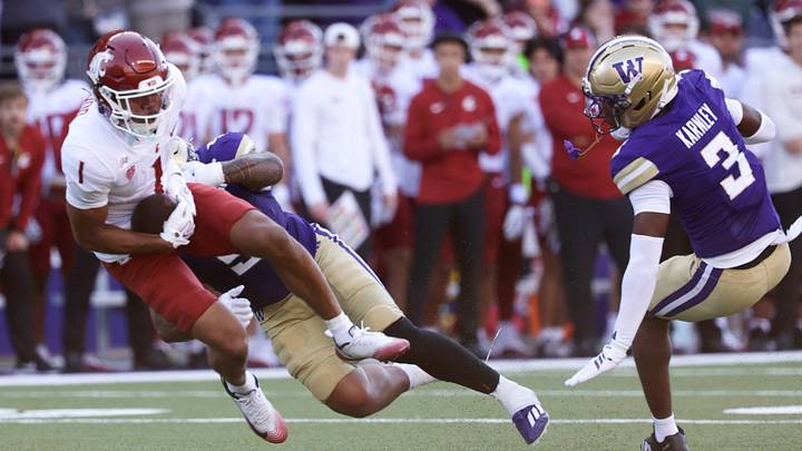 Washington State Cougars wide receiver Daniel Blood (1) is tackled by Washington Huskies defensive line Derek Colman-Brusa (5) during the fourth quarter at Husky Stadium Washington State Cougars wide receiver Daniel Blood (1) is tackled by Washington Huskies defensive line Derek Colman-Brusa (5) during the fourth quarter at Husky Stadium