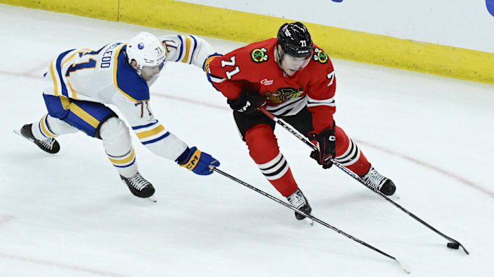 Oct 19, 2024; Chicago, Illinois, USA;  Chicago Blackhawks left wing Taylor Hall (71) and Buffalo Sabres center Ryan McLeod (71) chase the puck during the third period at the United Center. Mandatory Credit: Matt Marton-Imagn Images