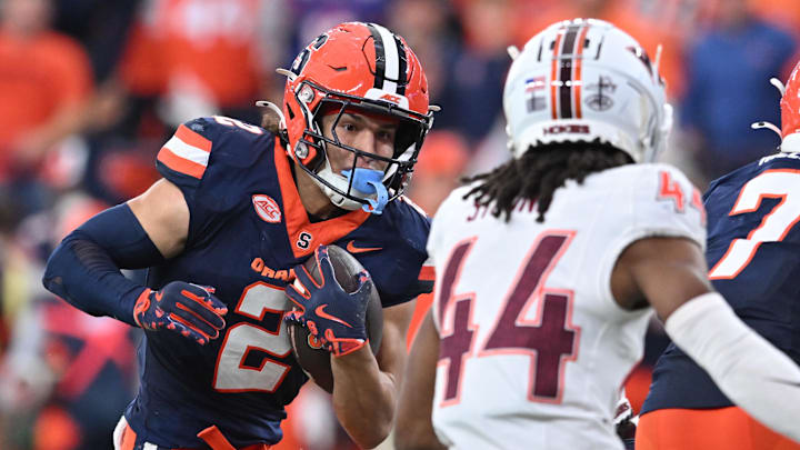 Nov 2, 2024; Syracuse, New York, USA; Syracuse Orange wide receiver Trebor Pena (2) tries to avoid a tackle by Virginia Tech Hokies cornerback Dorian Strong (44) in the third quarter at JMA Wireless Dome. Mandatory Credit: Mark Konezny-Imagn Images