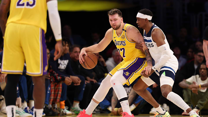 Los Angeles Lakers guard Luka Doncic posts up against Minnesota Timberwolves forward Jaden McDaniels during the first quarter of Game 2 of their first-round playoff series at Crypto.com Arena in Los Angeles on April 22, 2025.