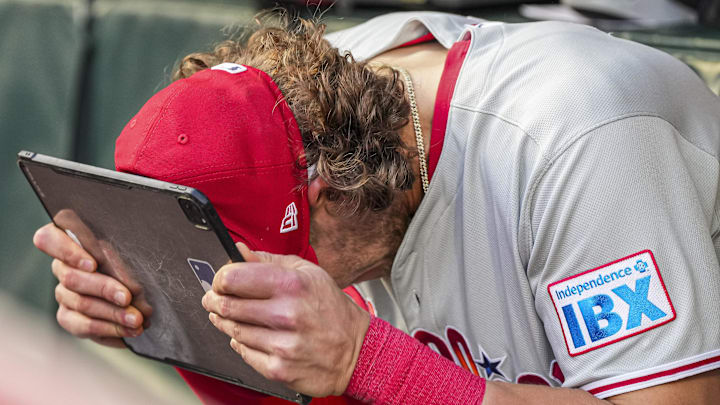 Apr 9, 2025; Cumberland, Georgia, USA; Philadelphia Phillies third base Alec Bohm (28) reacts in the dugout against the Atlanta Braves during the second inning at Truist Park