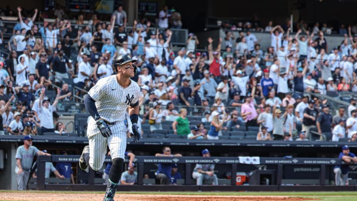 Aug 11, 2024; Bronx, New York, USA; New York Yankees center fielder Aaron Judge (99) hits a solo home run during the seventh inning against the Texas Rangers at Yankee Stadium. Mandatory Credit: Vincent Carchietta-USA TODAY Sports