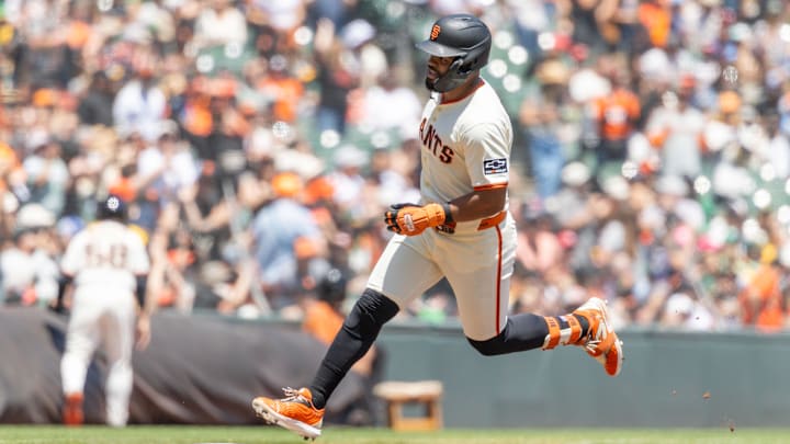 May 18, 2025; San Francisco, California, USA; San Francisco Giants first base LaMonte Wade Jr. (31) heads home to score a run during the eighth inning against the Athletics at Oracle Park. Mandatory Credit: Bob Kupbens-Imagn Images