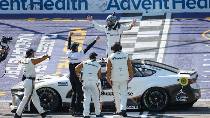 Apr 19, 2026; Kansas City, Kansas, USA; NASCAR Cup Series driver Tyler Reddick (45) celebrates with some of his team after winning the AdventHealth 400 at Kansas Speedway.