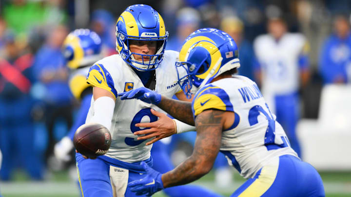 Nov 3, 2024; Seattle, Washington, USA; Los Angeles Rams quarterback Matthew Stafford (9) hands the ball off to running back Kyren Williams (23) during the second half against the Seattle Seahawks at Lumen Field. Mandatory Credit: Steven Bisig-Imagn Images