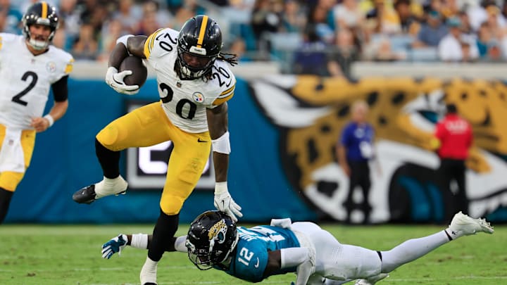 Pittsburgh Steelers running back Kaleb Johnson (20) outpaces Jacksonville Jaguars wide receiver Travis Hunter (12) who can’t make the tackle during the second quarter of an NFL preseason matchup at EverBank Stadium, Saturday, Aug. 9, 2025 in Jacksonville, Fla. [Corey Perrine/Florida Times-Union]