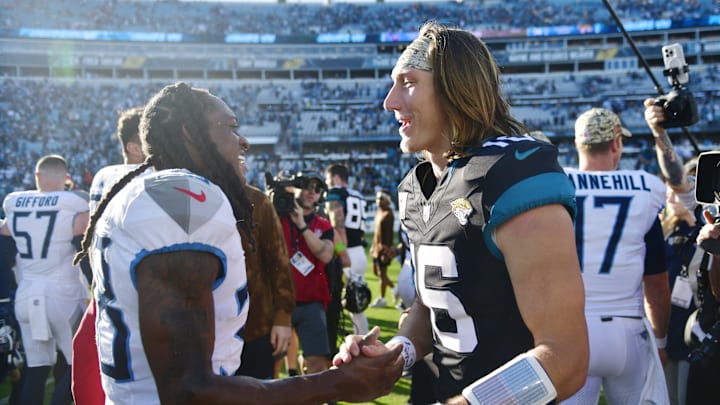 Jacksonville Jaguars quarterback Trevor Lawrence (16) shakes hands with Tennessee Titans safety