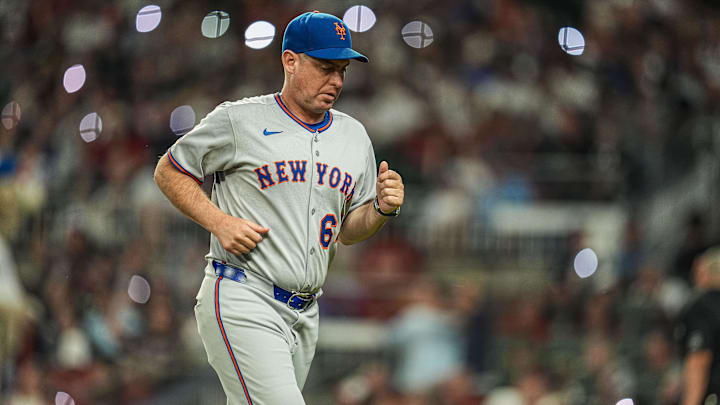 Aug 23, 2025; Cumberland, Georgia, USA; New York Mets manager Carlos Mendoza (64) on the field during the game against the Atlanta Braves during the seventh inning at Truist Park. 