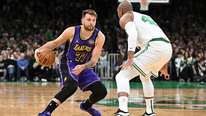 Mar 8, 2025; Boston, Massachusetts, USA; Los Angeles Lakers guard Luka Doncic (77) dribbles the ball against Boston Celtics center Al Horford (42) during the first quarter at the TD Garden. Mandatory Credit: Brian Fluharty-Imagn Images