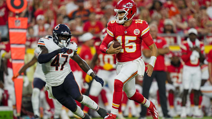 Aug 22, 2025; Kansas City, Missouri, USA; Kansas City Chiefs quarterback Patrick Mahomes (15) runs the ball against Chicago Bears linebacker Ruben Hyppolite II (47) during the first half at GEHA Field at Arrowhead Stadium. Mandatory Credit: Jay Biggerstaff-Imagn Images