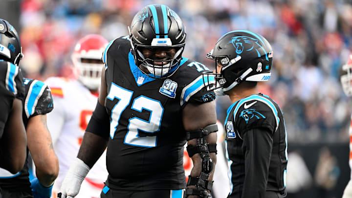 Nov 24, 2024; Charlotte, North Carolina, USA; Carolina Panthers offensive tackle Taylor Moton (72) with Carolina Panthers quarterback Bryce Young (9) in the fourth quarter at Bank of America Stadium. Mandatory Credit: Bob Donnan-Imagn Images Nov 24, 2024; Charlotte, North Carolina, USA; Carolina Panthers offensive tackle Taylor Moton (72) with Carolina Panthers quarterback Bryce Young (9) in the fourth quarter at Bank of America Stadium. Mandatory Credit: Bob Donnan-Imagn Images