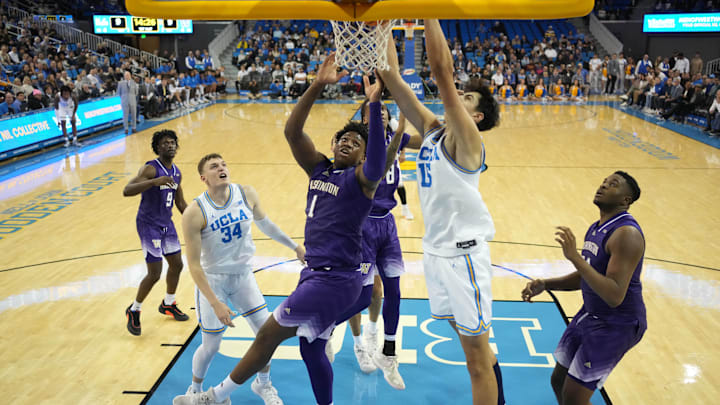 Huskies Great Osobor (1) and KC Ibekwe (24) can't stop UCLA center Aday Mara (15) from dunking in Tuesday's game in Los Angeles.