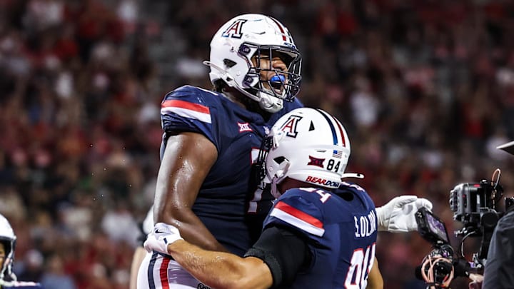 Aug 30, 2025; Tucson, Arizona, USA; Arizona Wildcats offensive lineman Michael Wooten (77) celebrates with tight end Sam Olson (84) during the third quarter of the game against the Hawaii Rainbow Warriors at Arizona Stadium. Mandatory Credit: Aryanna Frank-Imagn Images Aug 30, 2025; Tucson, Arizona, USA; Arizona Wildcats offensive lineman Michael Wooten (77) celebrates with tight end Sam Olson (84) during the third quarter of the game against the Hawaii Rainbow Warriors at Arizona Stadium. Mandatory Credit: Aryanna Frank-Imagn Images