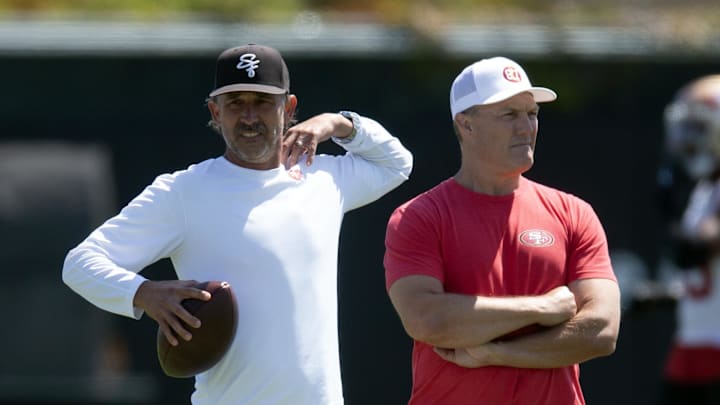 Jun 10, 2025; Santa Clara, CA, USA; San Francisco 49ers head coach Kyle Shanahan (left) and general manager John Lynch watch their team work out during an OTA at Levi's Stadium. Mandatory Credit: D. Ross Cameron-Imagn Images