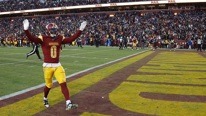 Dec 22, 2024; Landover, Maryland, USA; Washington Commanders cornerback Mike Sainristil (0) celebrates after the Commanders' game against the Philadelphia Eagles at Northwest Stadium. Mandatory Credit: Geoff Burke-Imagn Images
